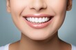 © Iftikhar alam - A woman with a toothbrush in her mouth showcases the importance of daily dental care and oral hygiene, Young woman showing healthy gums on grey background, AI Generated