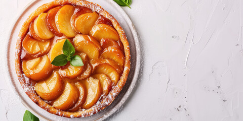 Caramelized Tarte Tatin on Rustic Table background, copy space. Close-up of a caramelized peach or apple tarte tatin, perfect for a sweet summer treat.