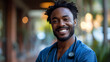  Black Male Nurse Smiling, Dressed in Blue Scrubs at Hospital