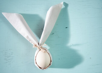 Wall Mural - egg wrapped in easter bunny shaped napkin