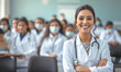 © Honey Bear - Female doctor smiling. Close-up portrait of a nurse against a blurred classroom background. Medical training concept.