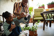 © Marko Geber - Father and daughter watering a plant at home together