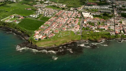 Wall Mural - Aerial shot, drone point of view rocky coastline, Atlantic Ocean coastline of Island of Sao Miguel, Azores, Portugal. Travel destinations and beauty in nature concept