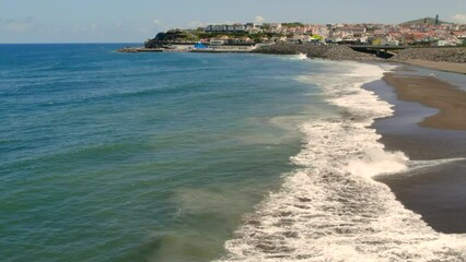 Sticker - Breaking waves of the Atlantic Ocean and sandy empty beach of Ribeira Grande town. Sao Miguel island, Ponta Delgada. Azores, Portugal
