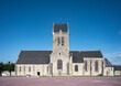 © Adolf - Detail of the pretty old church of Sainte Mere Eglise with the airborne military soldier from the second world war hanging from the bell tower