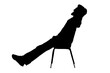 © Curto - silhouette of a man sitting and relaxing in a chair