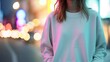 Woman wearing a clean white sweatshirt. On a light blurred background. Outdoors. Sweatshirt Mockup. Concept of urban fashion, street style, template for design