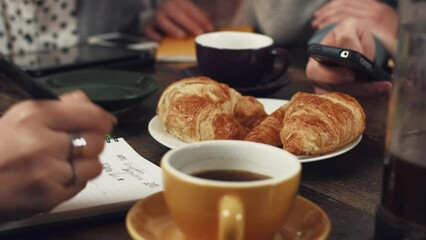 Poster - Hands, collaboration and business people meeting at breakfast for planning, writing or morning strategy. Food, technology and professional employee group in coffee shop, or restaurant for teamwork