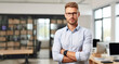 © YannTouvay - business, people and office concept - smiling businessman in eyeglasses with crossed arms over office background