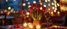Romantically Decorated Restaurant Table For A Luxurious Candlelit Dinner On Valentine's Day, With Tulip Flower Decorations And Candles For A Surprise Proposal.