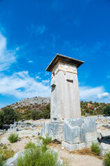 Wall Mural - Xanthos Ancient City archaeology site. Grave monument and the ruins of ancient city of Xanthos in Kas, Antalya, Turkey at sunset. Capital of Lycia.