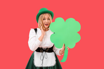 Poster - Surprised woman with paper clover on red background. St. Patrick's Day celebration