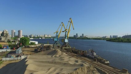 Wall Mural - Cranes work in South River Port at sunny day. Aerial view