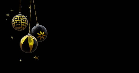 Poster - Black and gold christmas baubles swinging with gold stars on black background, copy space