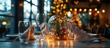 Christmas Decoration With Fairy Lights And Paper Napkins Placed Under Glass Dome On Cafe Table.