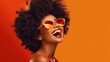 © Alex - Beautiful african american woman with afro hairstyle and sunglasses on orange background Generative AI