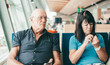 © luciano - Angry senior couple ignoring each other sitting in airport departure area waiting for boarding.