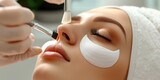 Fototapeta  - Beauty salon. Young woman undergoing procedure of eyelashes lamination