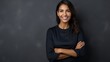 © Phoophinyo - Portrait of young Mexican woman with pleasant smile and arms crossed isolated on gray wall with copy space Beautiful young woman with folded arms looking at camera against gray wall. isolated studio