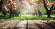 © jex - A beautiful spring background with an empty wooden table set in the outdoor nature, surrounded by blooming trees.