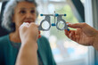 © Drazen - Close up of ophthalmologist using optical trial frame during patient's eyesight exam.