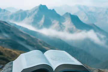 Open book page showcasing a mountain range, with small, misty clouds floating up from the peaks
