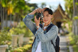 © saltdium - Asian male tourist with backpack traveling and taking photos in Temple, Chiangmai, Thailand, Solo Traveler concept