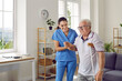 © Studio Romantic - Friendly female nurse helping an injured senior man walk with a crutch, holding his hand, supporting him. Treatment and rehabilitation after injury, assisted living facility, senior care concept