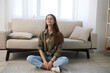 © SHOTPRIME STUDIO - Cosy Home Retreat: Meditating Woman on Sofa, Creating Mental Wellness