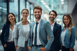© Surachetsh - A positive atmosphere fills the office as businesspeople and their team strike a group pose, their body language reflecting a collective energy. Generative AI.