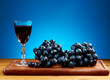 Bunch of grapes and a Wine jug on a dark wooden background