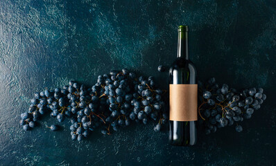 Poster - Bottle of red wine and grapes on a blue vintage background.