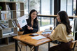 © Wasana - Two asian businesswoman accountants discuss financial management planning. Analysis of new startup project ideas