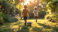 Two Spanish Boys 10 Years Old Play Football In The Summer Garden