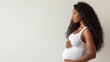 © Kate Mova - pregnant black woman in a white T-shirt holds hands on big belly , Pregnancy, maternity, preparation and expectation, copyspace for text