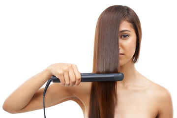 Hair care, straightener and young woman in studio for cosmetic, salon and beauty treatment. Flat iron tool, confident and portrait of female person with healthy hairstyle routine by white background.