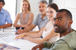 © Yuri A for PeopleImages/peopleimages.com - Magazine, design and portrait of team in meeting with man on project, collaboration and creative planning. Happy, staff and photography work on table with catalog, portfolio and editing process