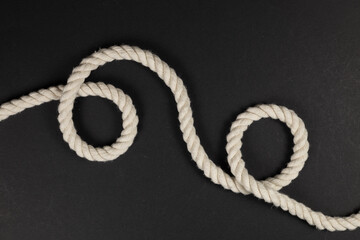 Wall Mural - beige rope on dark background close up