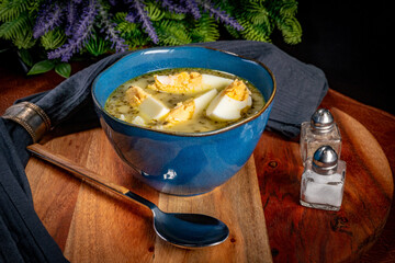 Wall Mural - A bowl of soup sorrel with rice and boiled egg.