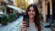 © tiagozr - Young woman holding blank screen smartphone