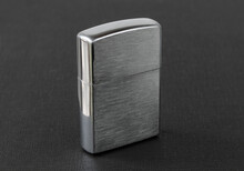 Windproof Petrol Lighter In Metal Style, On A Dark Textured Background