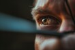 Sharp Focus: A Close-Up of an Archer's Eye Through the Sight Pin