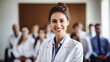 Capturing the essence of confidence and professionalism, a female doctor or nurse stands in the front row of a medical training class or seminar room, smiling cheerfully, with ample copy space