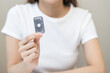 © KMPZZZ - Emergency contraception and pregnancy concept asian young woman hand holding birth control pills, hormonal oral contraceptive medicine at home, take pharmaceutical to prevention virus sex disease.