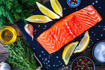 Poster - Fresh raw salmon steak with fresh vegetables on wooden background

