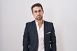 © Krakenimages.com - Handsome business hispanic man standing over white background depressed and worry for distress, crying angry and afraid. sad expression.