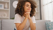 © Krakenimages.com - Young beautiful hispanic woman sitting on sofa with serious expression at home