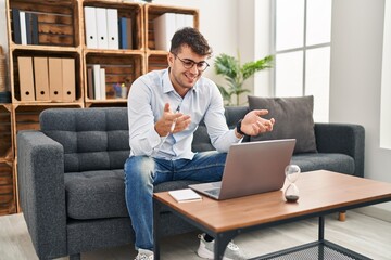 Wall Mural - Young hispanic man psychologist having online session at psychology clinic