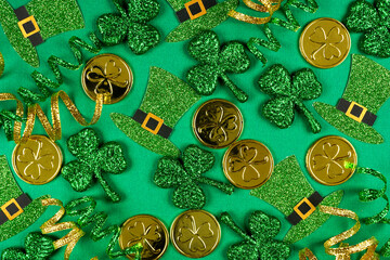 Poster - St Patricks Day background of  green shamrocks, leprechaun hats, gold coins and ribbon. Overhead view.
