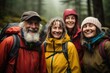 © Baba Images - Group portrait of smiling senior people hiking in rain forest